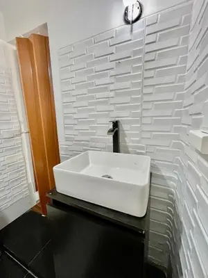 a bathroom with a white sink on a black counter at Apartment with 3 bedrooms near the sea in Miraflores in Lima