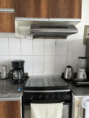 a kitchen with a stove top oven in a kitchen at Apartment with 3 bedrooms near the sea in Miraflores in Lima