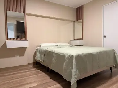 a bedroom with a large bed with two mirrors at Apartment in Victoria in Lima