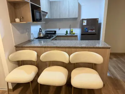 a kitchen with two chairs and a counter with a stove at Apartment in Victoria in Lima
