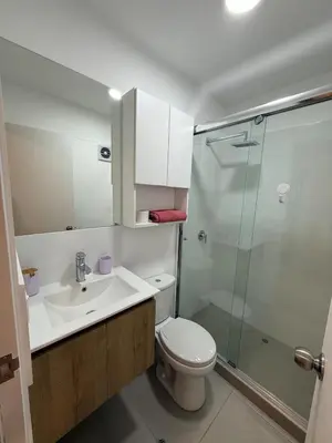 a bathroom with a toilet and a sink and a shower at Apartment in Victoria in Lima
