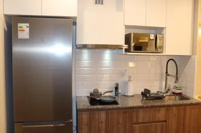 a kitchen with a refrigerator and a counter top at Ama Loft Miraflores in Lima