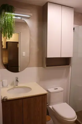 a bathroom with a sink and a toilet and a mirror at Ama Loft Miraflores in Lima