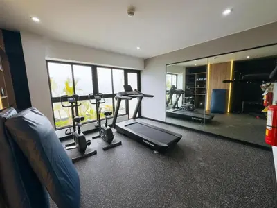 a gym with two exercise bikes and a mirror at Ama Loft Miraflores in Lima
