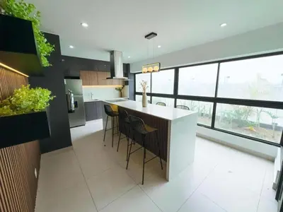 a kitchen with a island with bar stools at Ama Loft Miraflores in Lima