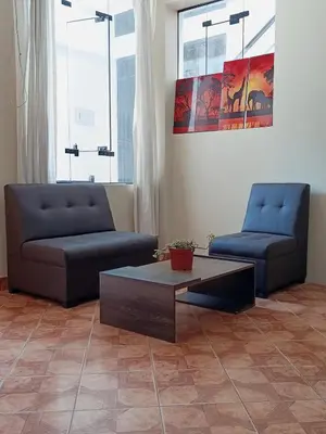 a living room with two couches and a coffee table at bambanhouse in Cusco