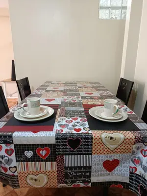 a table with two cups and a quilt on it at bambanhouse in Cusco