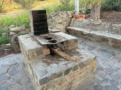 an outdoor brick oven sitting on a stone ground at Casa Huerta Vista Bonita in Canta