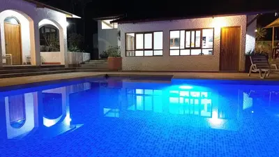 a swimming pool in front of a house at night at Casa Huerta Vista Bonita in Canta