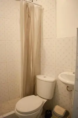 a bathroom with a toilet and a sink at Mini departamento con cochera in Ayacucho