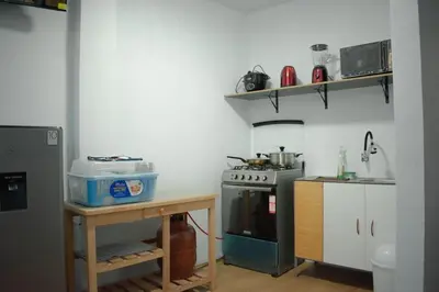 a kitchen with a stove and a table in it at Mini departamento con cochera in Ayacucho