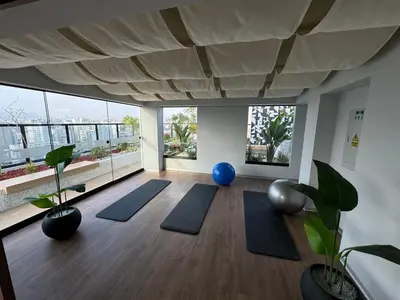a yoga room with blue mats and large windows at Cozy Room in Miraflores with rooftop pool in Lima