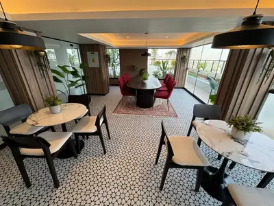 a room with two tables and chairs and a living room at Cozy Room in Miraflores with rooftop pool in Lima