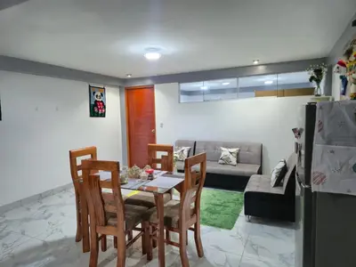 a living room with a table and chairs and a couch at Camino del Sol in Cusco