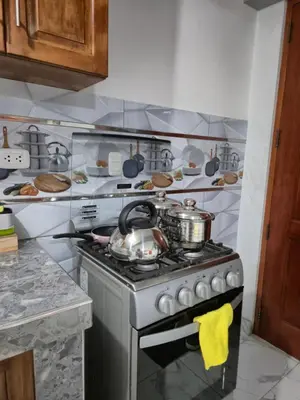 a kitchen with a stove with pots and pans at Camino del Sol in Cusco