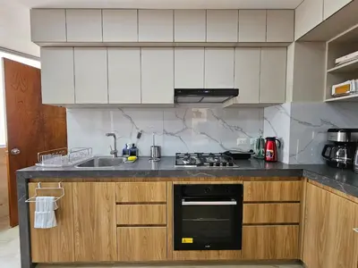 a kitchen with a sink and a stove top oven at Apartamento renovado en Miraflores in Lima