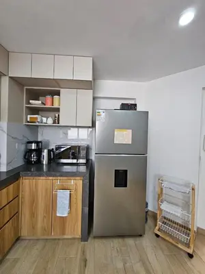 a kitchen with a stainless steel refrigerator in a room at Apartamento renovado en Miraflores in Lima