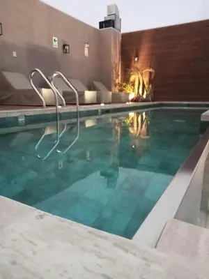 a large swimming pool with a blue at Edificio The sight Barranco vista al mar in Lima