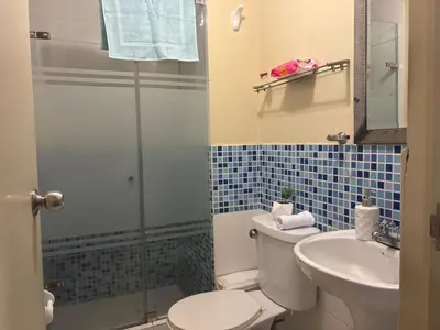 a bathroom with a toilet and a sink and a shower at Three-bedroom apartment in San Miguel in Lima