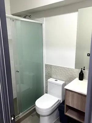 a bathroom with a shower and a toilet and a sink at Beautiful Modern Apartment in Lima in Lima