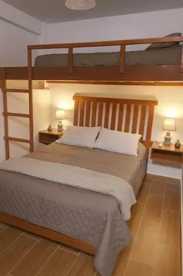 a bedroom with two bunk beds and two lamps at Suspiros de arica in Arica