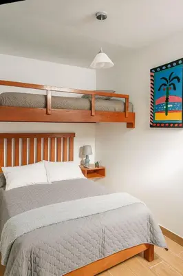 a bedroom with a bed and two bunk beds at Suspiros de arica in Arica