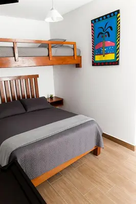a bedroom with a bed and two bunk beds at Suspiros de arica in Arica