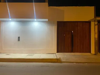a room with a wooden door and a wall at Suspiros de arica in Arica