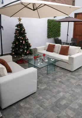 a living room with a christmas tree and white couches at Suspiros de arica in Arica