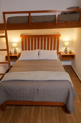 a bedroom with a bed with two bunk beds at Suspiros de arica in Arica
