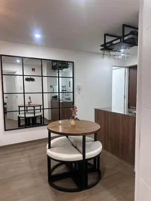 a room with a table and two chairs and a counter at moderno departamento con vista al mar en miraflores in Lima