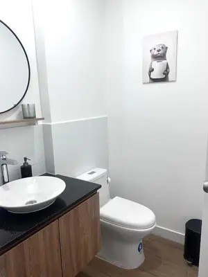a bathroom with a white toilet and a sink at moderno departamento con vista al mar en miraflores in Lima