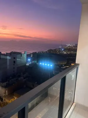 a view from the balcony of a building at night at moderno departamento con vista al mar en miraflores in Lima