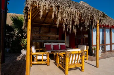 a hut with chairs and a table and a bed at Linda Casa de playa con vista al mar de Wakama in Jaguay