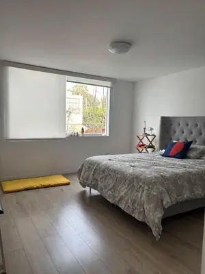 a bedroom with a large bed and a window at Casa amplia y acogedora, en Miraflores in Lima
