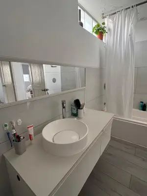 a white bathroom with a sink and a mirror at Casa amplia y acogedora, en Miraflores in Lima