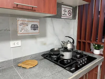 a kitchen stove with a tea kettle on top of it at Casa de Moño - Moderno apartamento cerca a Aeropuerto y Terminal Terrestre in Lima