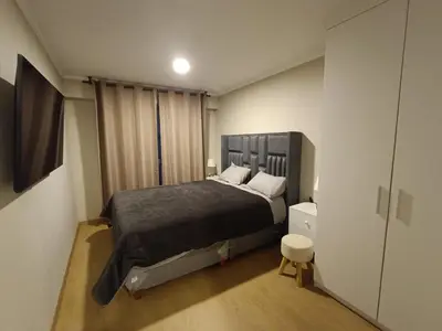 a bedroom with a large bed in a room at Apartment overlooking the water park in Lima