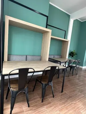 a row of tables and chairs in a room at Apartment overlooking the water park in Lima