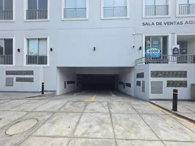 a parking lot in front of a building at Apartment overlooking the water park in Lima