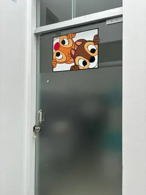 a door with two cartoon dogs stickers on it at Beach house - Alto Bujama Condominium in Asia