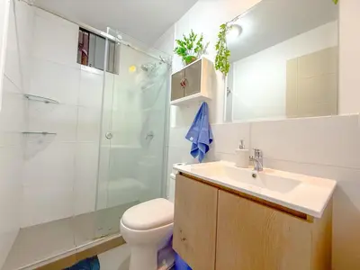 a bathroom with a shower and a toilet and a sink at Modern XXL Apartment in San Miguel in Lima