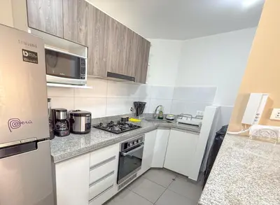 a kitchen with a stove and a refrigerator at Modern XXL Apartment in San Miguel in Lima