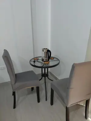 a table with two chairs and a tea kettle on it at Habitacion Matrimonial con Baño Privado Entrada Independiente in Ica