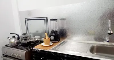 a kitchen counter with a stove with a blender on it at Habitacion Matrimonial con Baño Privado Entrada Independiente in Ica