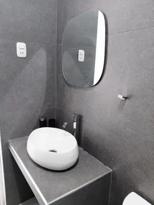 a bathroom with a white sink and a mirror at Habitacion Matrimonial con Baño Privado Entrada Independiente in Ica