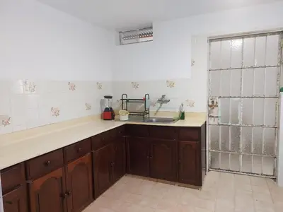 a kitchen with a sink and a counter top at KUSIHaus due in Lima