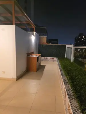 a rooftop patio at night with a view of the city at Barranco sea in Lima