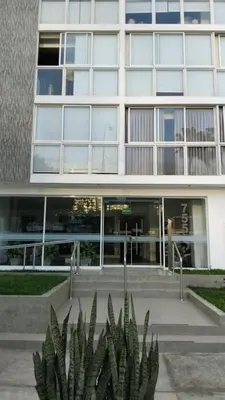 a building with a plant in front of it at Barranco sea in Lima