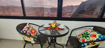 a table and chairs in a room with a view at Vistas increíbles desde San Blas 4 in Cusco